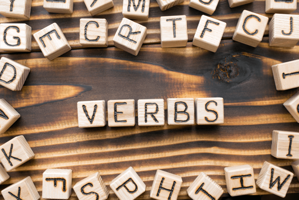 word blocks spelling the word 'verb' a part of a complete sentence.