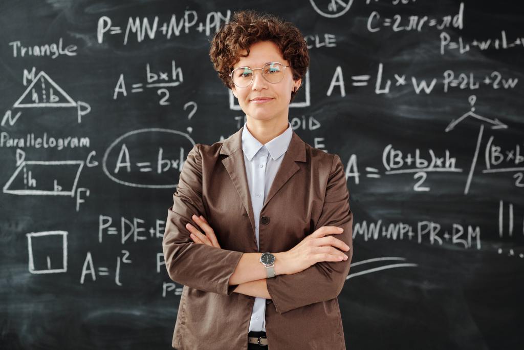 teacher standing in front of chalkboard with math formulas